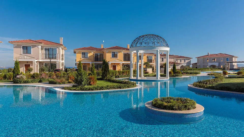 Pool area with a white domed pavilion at Victoria Residences